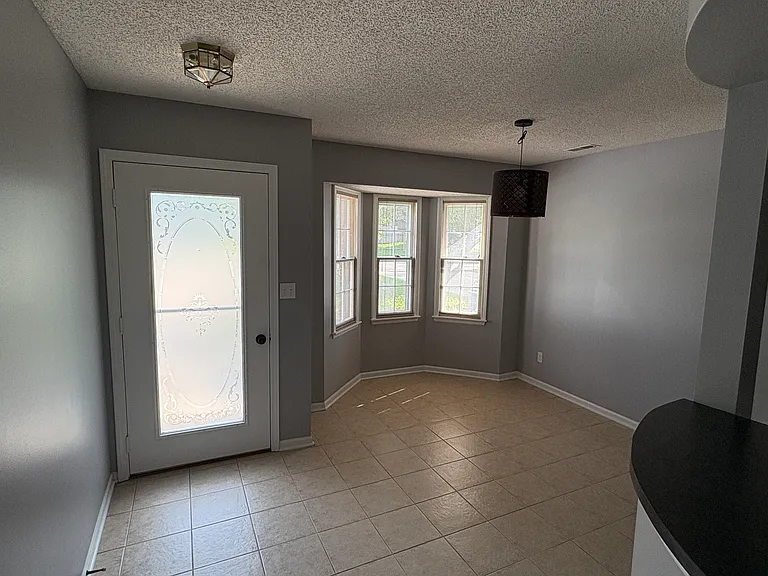 Front door and dining area with fresh paint.
