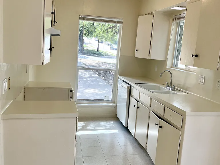 This bright kitchen has fresh paint & new mini blinds. A new refrigerator & oven are coming soon!