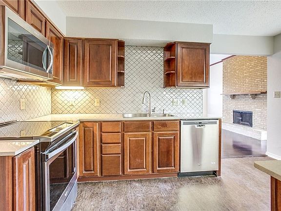 The kitchen has new appliances, new quartz countertops, new backsplash, and new flooring.