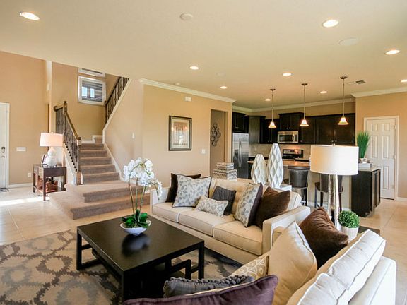 Model Representation; Open concept gathering room with stairs leading to 2nd floor