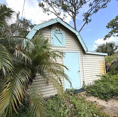 Large storage shed with attic and side addition. There is electricity so it's a great place for a workshop. There is even a built-in work table and plenty of room for tools and storage. This frees up the garage for your car