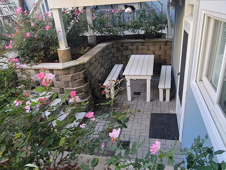 Step out onto your private flower-filled patio _ a charming outdoor space ideal for unwinding after a long day.
