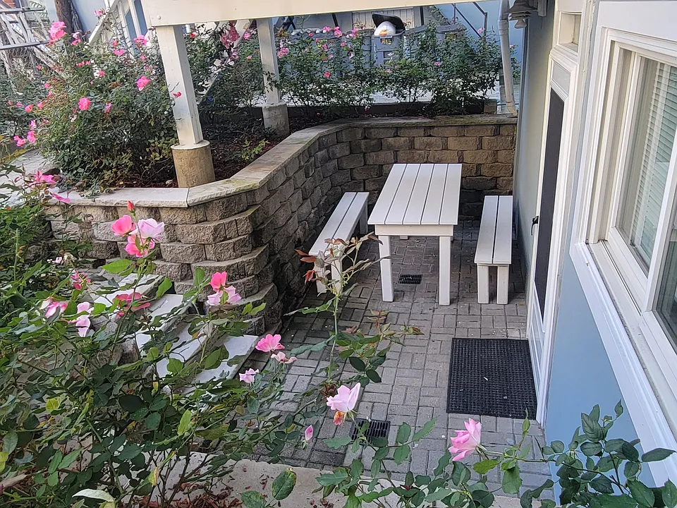 Step out onto your private flower-filled patio _ a charming outdoor space ideal for unwinding after a long day.
