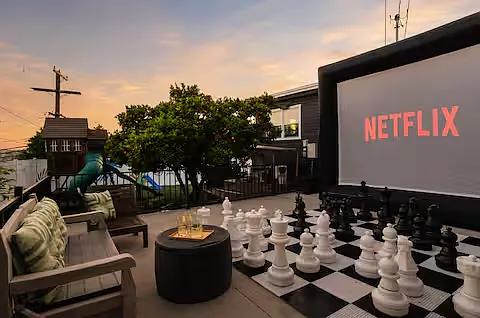 Spacious backyard packed with fun! Comfortable lounges, gather around the fire pit, cook on the pizza oven or BBQ, play the giant chess set, enjoy the playground, or watch movies on the large projector screen. Endless ways to play and unwind.