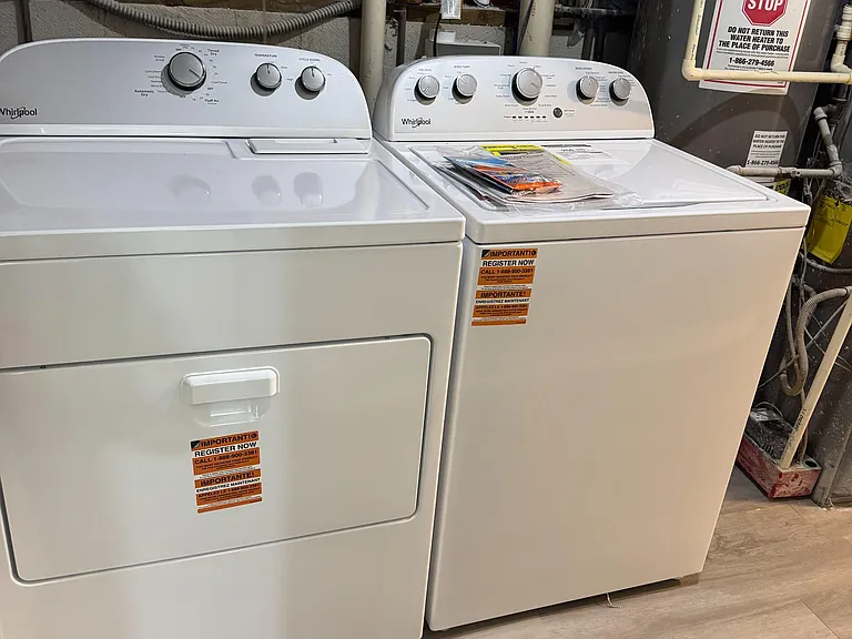 Dedicated laundry area with a full-size washer and dryer for convenient in-home laundry care.