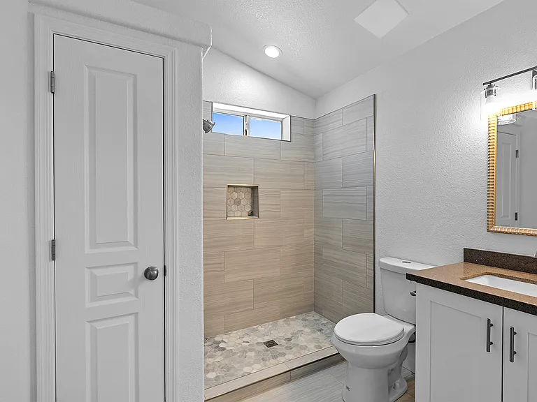 Master bathroom; glass doors have been added-no need for shower curtain. Linen closet.