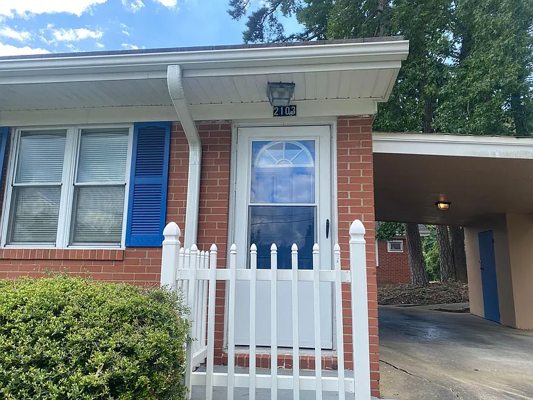 Private carport, in-unit laundry, and the Lakewood strip right outside your door. — Photo 3