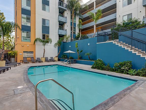 Swimming pool with lounge chairs and plants.