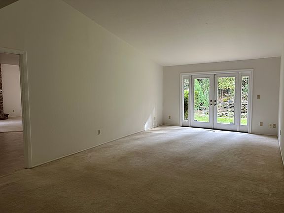 Entertainer's living room with French doors to the large backyard.