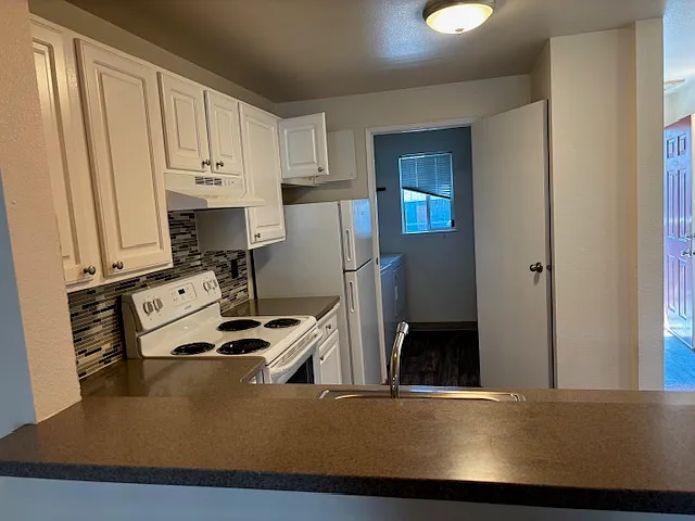 View from dining area through kitchen to laundry room