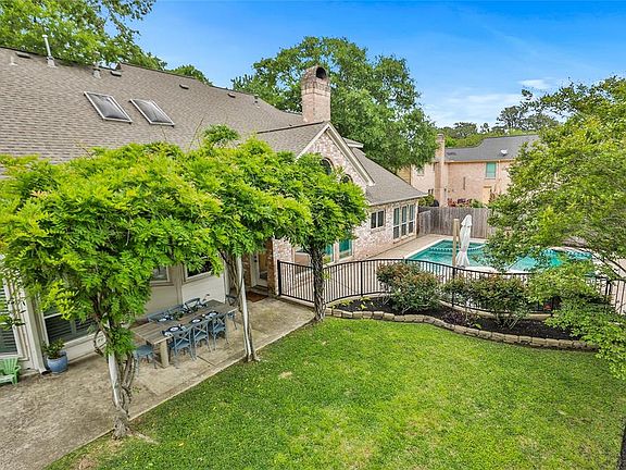 LUSH BACKYARD ; In addition to the pool and spa, there is a large grass yard and a wisteria-covered patio - perfect for entertaining your family and friends. Just in time for summer!