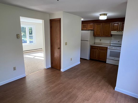 View from dining room of kitchen, coat closet, and living room.
