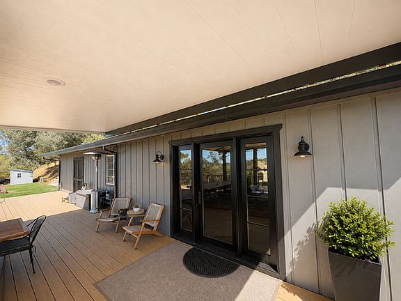 Modern glass and steel front doors allow for easy access to covered deck space.