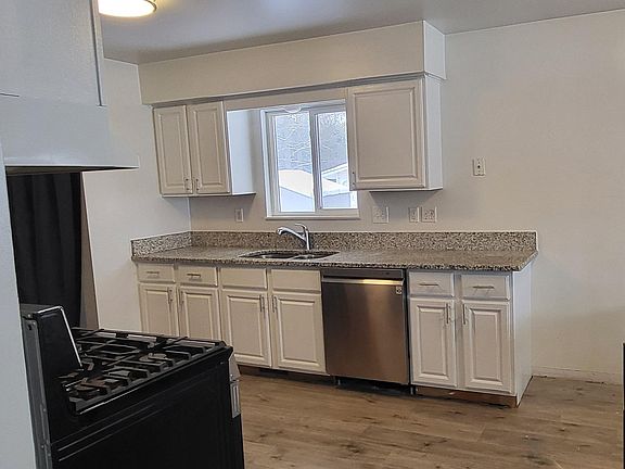 Kitchen with new stainless steel appliances, granite countertops, new luxury vinal plank flooring.