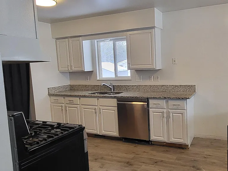 Kitchen with new stainless steel appliances, granite countertops, new luxury vinal plank flooring.