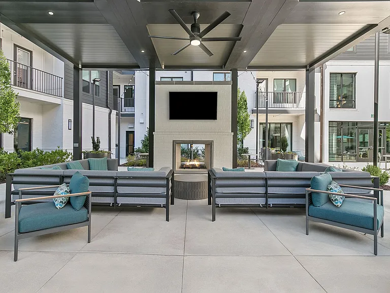 Relax in the outdoor living room with fireplace and TVs