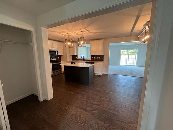 Coat closet,, entry from garage on left, kitchen & dining, sliding door in living room to deck