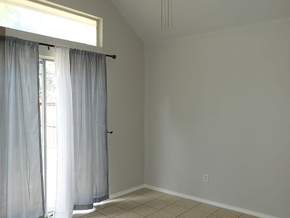 Eating area with sliding glass doors to backyard, ceiling fan.