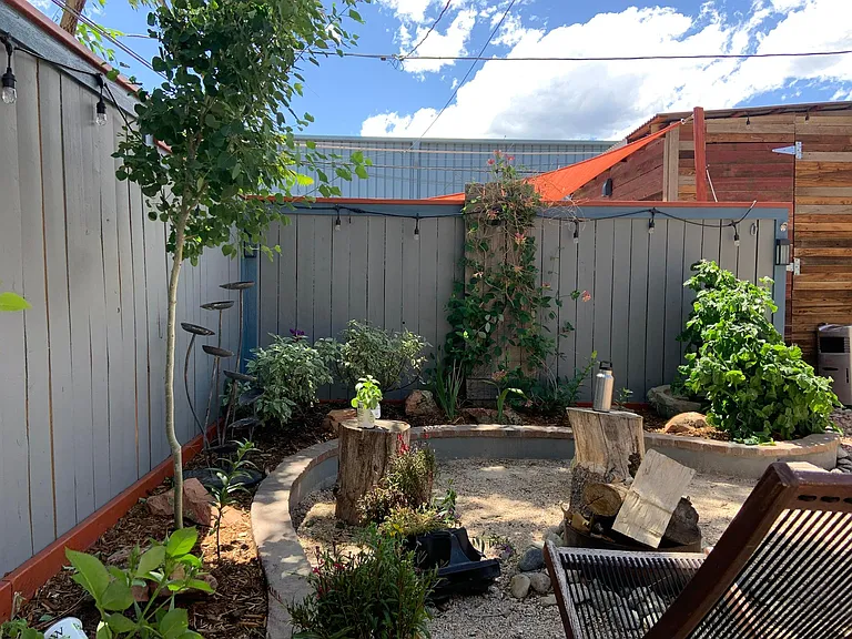 Landscaped backyard with firepit with two lockable sheds. Lock provided by landlord for large shed and dusk to dawn light for parking spot behind shed.