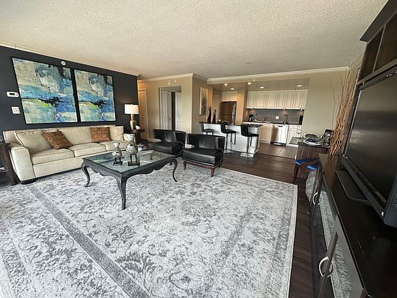 HUGE 2 BEDROOM LIVING ROOM, WOOD VINYL FLOORS, BLACK GRANITE KITCHEN ISLAND AND COUNTERS, STAINLESS STEEL APPLIANCES