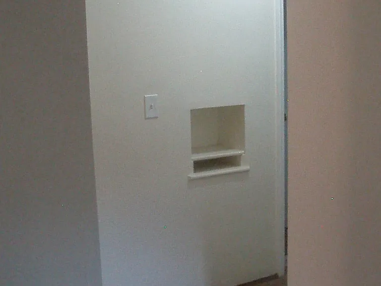 Hallway leading to bedrooms and bath. also has cubby for phones and mail.