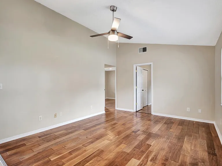 Family room and door to bedroom 1. Hallway to bedroom 2 and guest bathroom