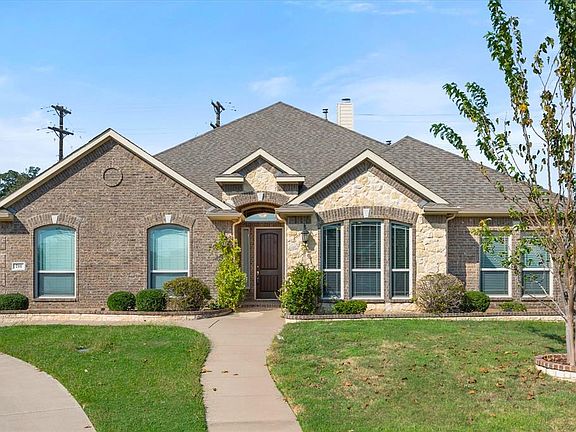 French country style house featuring a front yard
