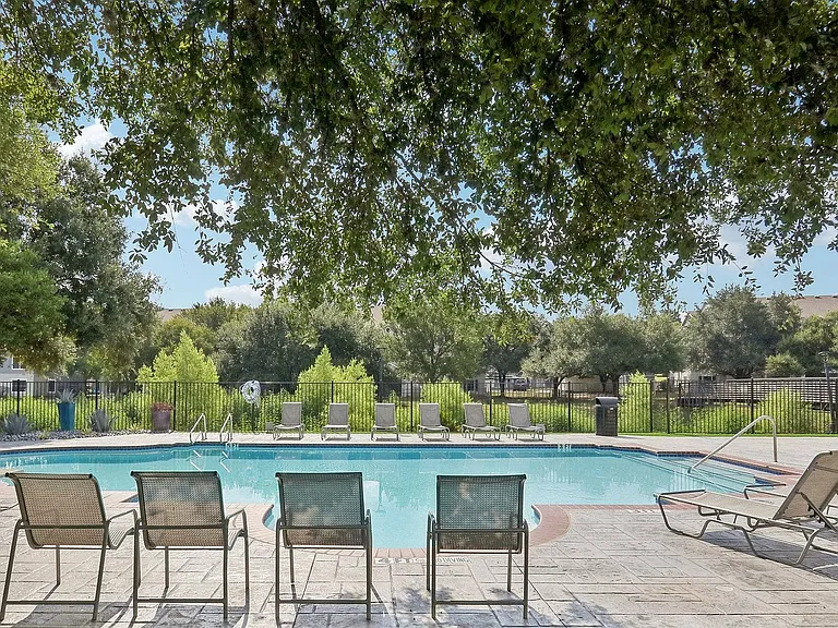 Relax and unwind in the resort-style pool at Avonmora, featuring lounge seating and shaded cabanas.
