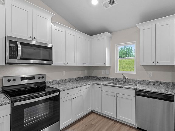 Stainless steel appliances are included in the kitchen