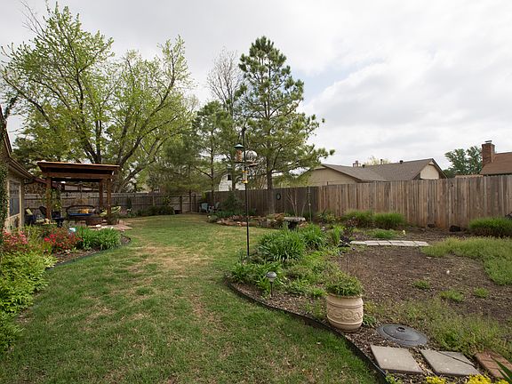 Linnaeus Certified Gardener yard designed to bloom all year long! Backyard is fully fenced with 3/4 privacy fencing and new security lighting has been installed all around home.