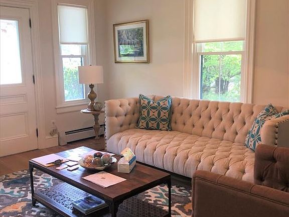 front parlor has etched glass French doors and marble mantel
