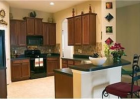 The kitchen - upgraded cherry wood cabinets, backsplash, appliances, etc