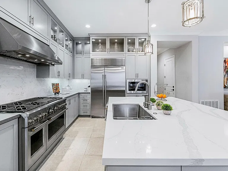 Speaking of perfect kitchen! Here it is! Extra large SUB ZERO refrigerator. GE Monogram Professional Gas Range with 6 Burners a grill and two ovens. A beautiful dream kitchen!