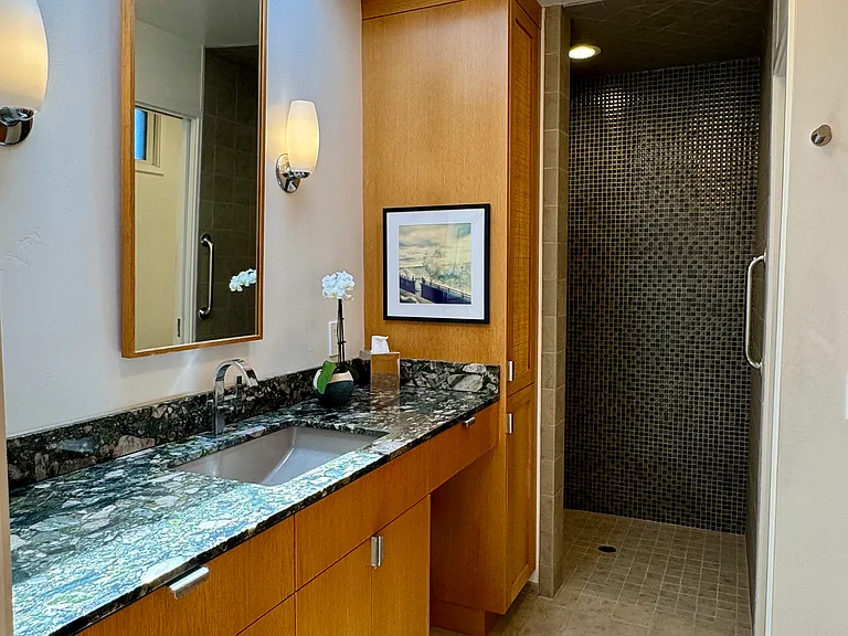 Full bathroom with walk-in shower, separate toilet room, full closet and drawers and ample undercounter storage