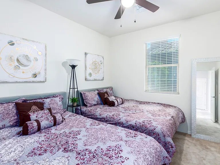 Bedroom 4, blinds and ceiling fan with lighting are installed to complete it. Staged to show you 2 queen beds or doubles/twins will fit if needed.