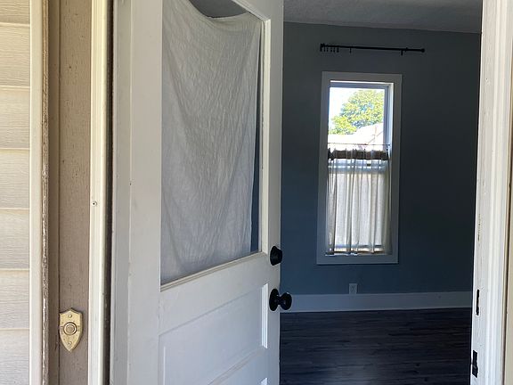 Front door entering into living room with 10 foot ceilings