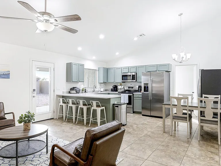 View of Living Area and Kitchen with back door.