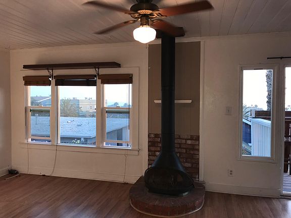 Fireplace in living room with hardwood laminate floors and views galore