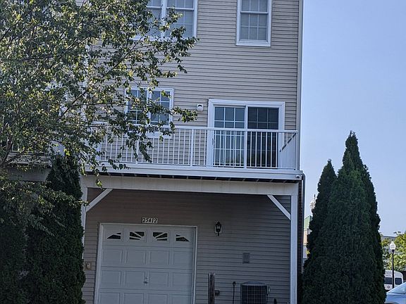 Back, with deck and garage.