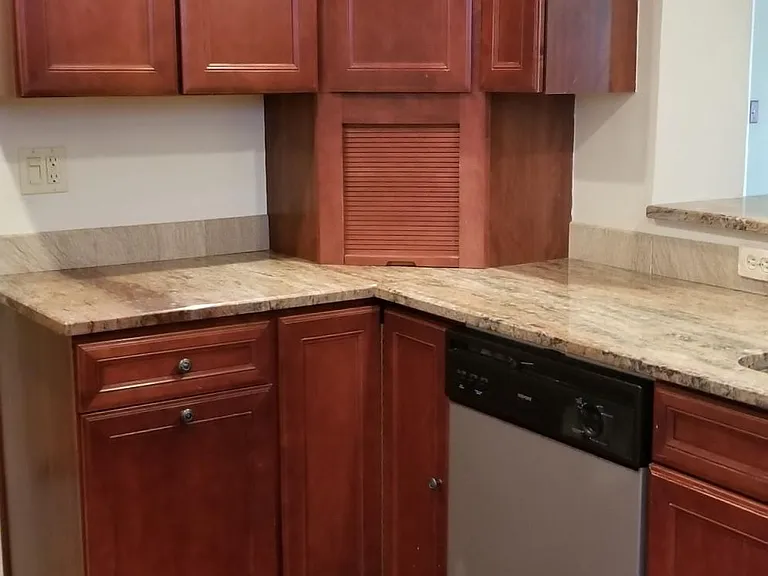 Kitchen with dishwasher and granite countertops