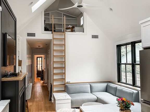 This photo was taken before the glass wall and door were installed on the loft. I will update when the current tenant vacates. There is a desk up there for a dedicated workspace.