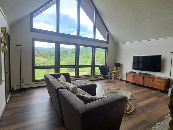 Living room with big views to the north over large yard. Access to deck.