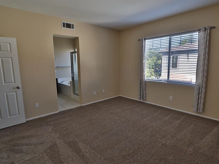 Large Master Suite with entrance to master bathroom. Includes new cordless blinds.