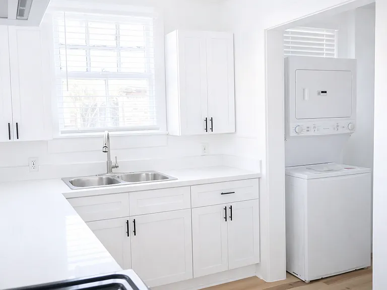 Light-filled kitchen with in-unit washer/dryer and ample cabinet storage
