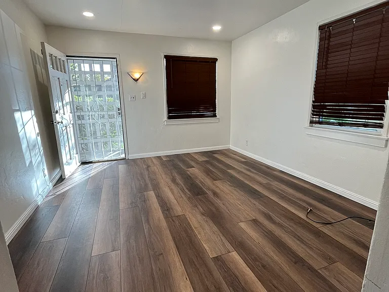 The living room is complete with new flooring and windows.