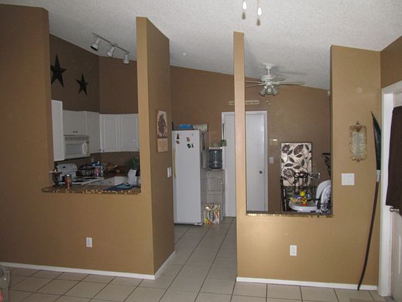 Looking into kitchen - eating area on right, appliances and cooking area on left