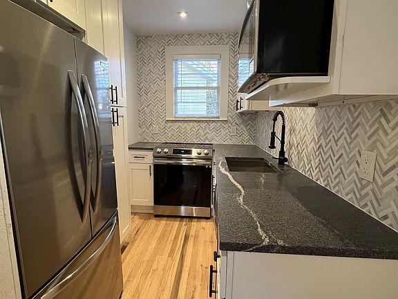 Kitchen also have large quartite countertop, french door refridgerator & wood floors.