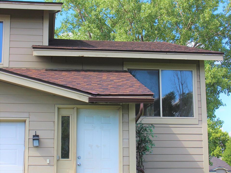 Outside of house. Nice yard in front. Large yard in back. Single car garage, two parking spots in driveway.