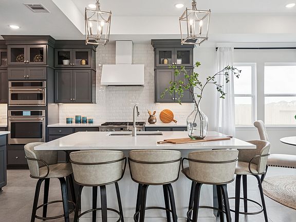 Kitchen with stacked glass-front upper cabinets