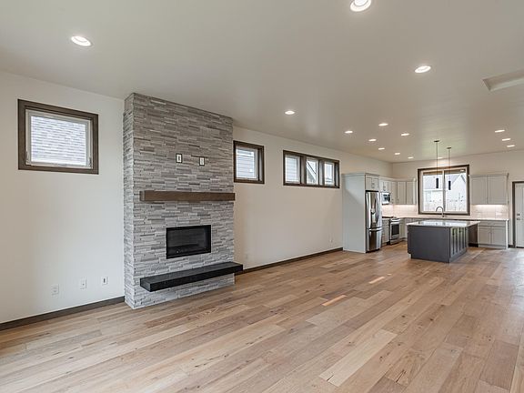 Open concept, modern fireplace w/ floating hearth and mantel and stone finish